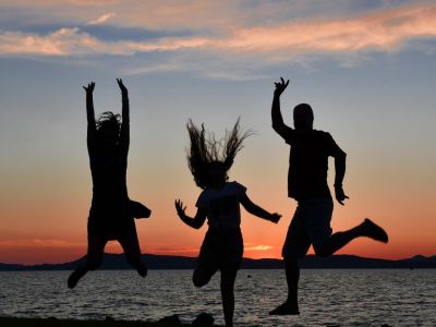 Familie springt im Sonnenuntergang